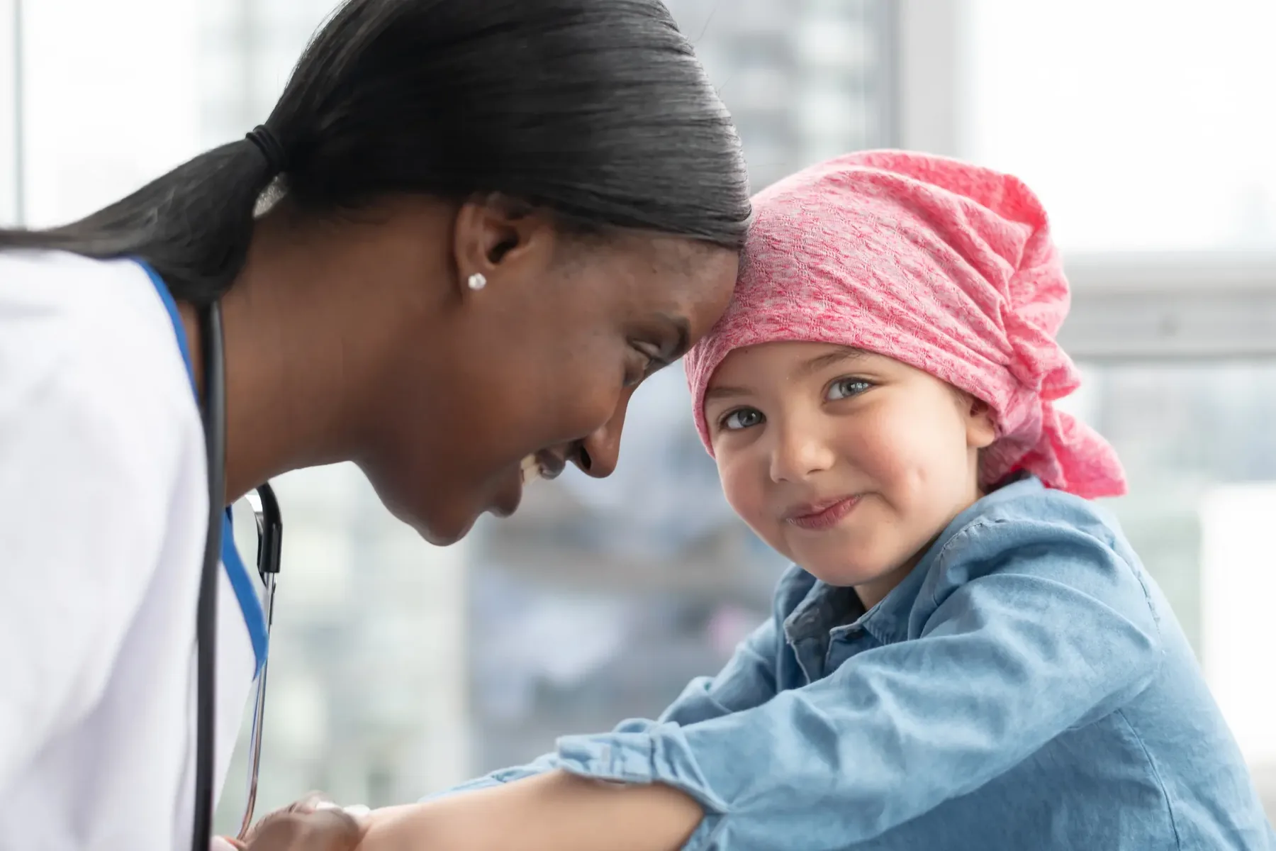 A clinician gently comforting a young patient